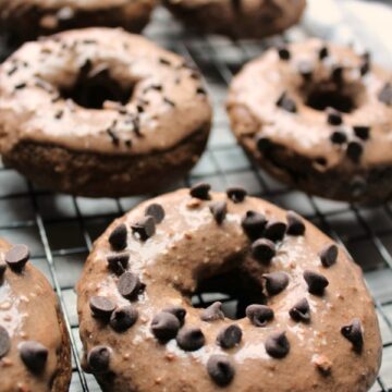 Frosted Chocolate Donuts on a baking rack