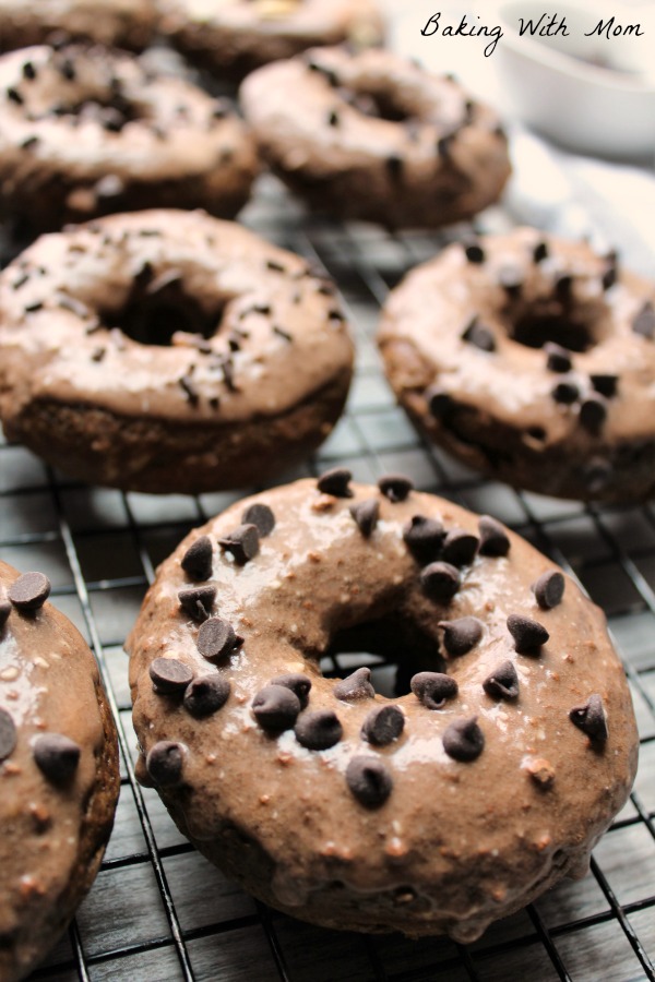 Frosted Chocolate Donuts on a baking rack 