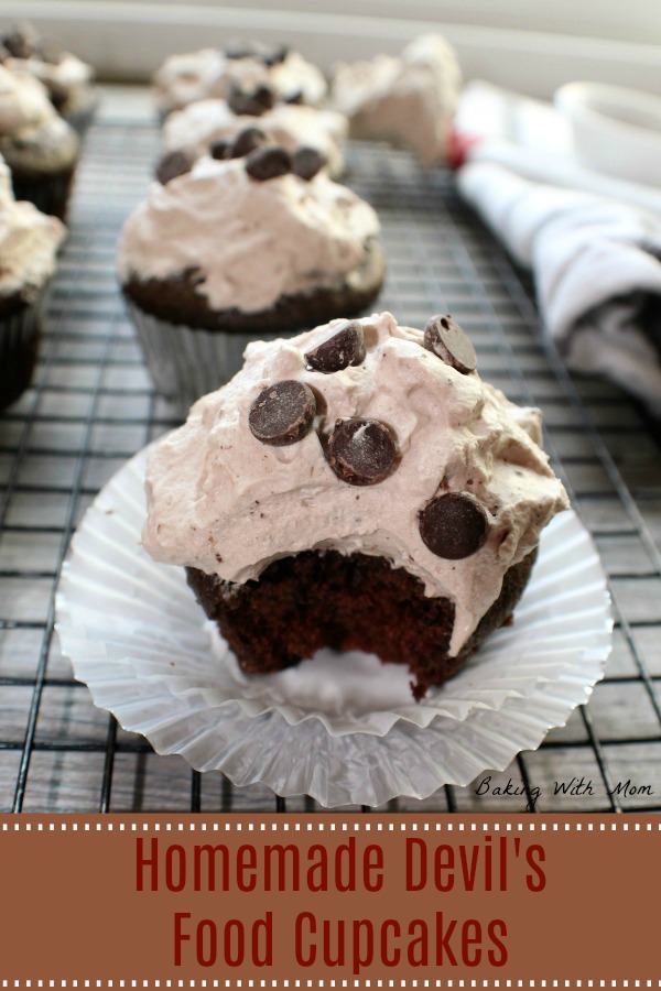 Homemade Devil's Food Cupcakes with whipping cream frosting on a cooling rack