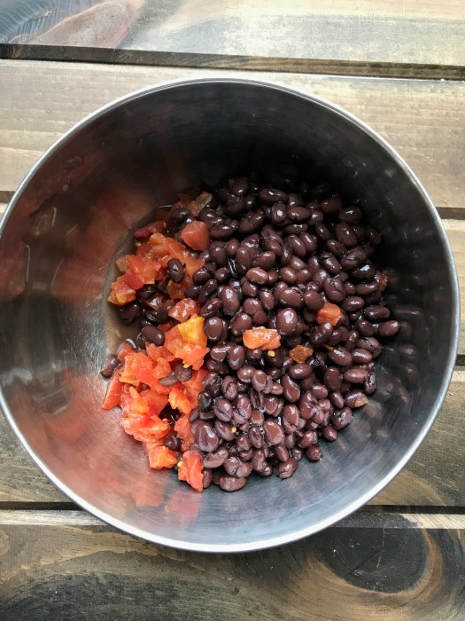 Beans and tomatoes in a silver bowl