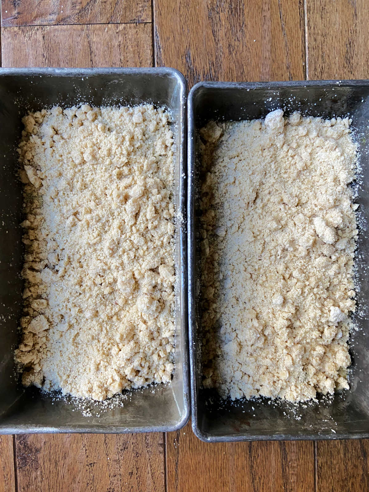 two loaf pans with bread batter inside. 
