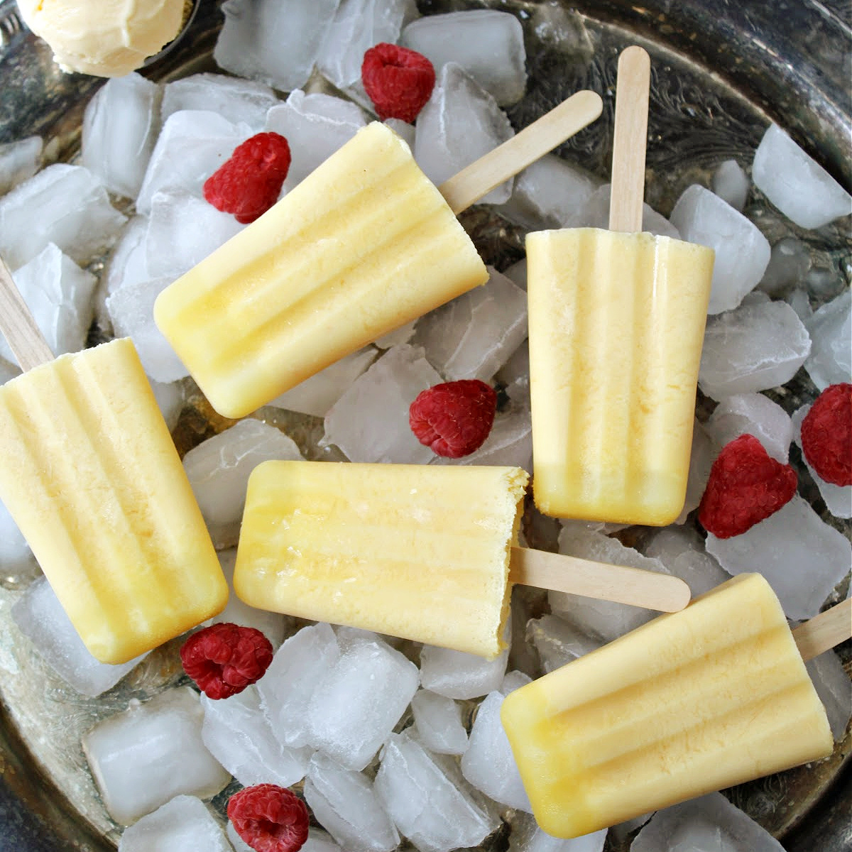 Orange creamsicle popsicles on a platter.