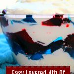 Red and Blue Jello with white whipping cream in a glass bowl