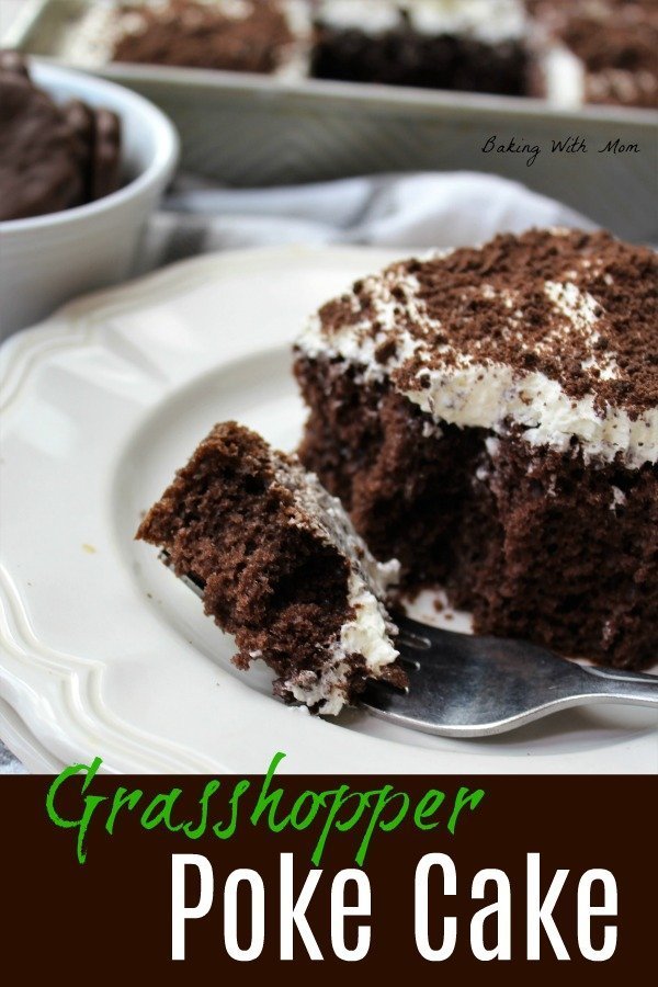 Grasshopper Poke Cake on a white plate with whipped cream and grasshopper cookies on top