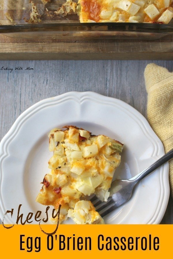 Piece of cheesy egg o'brien casserole with a fork on a white plate