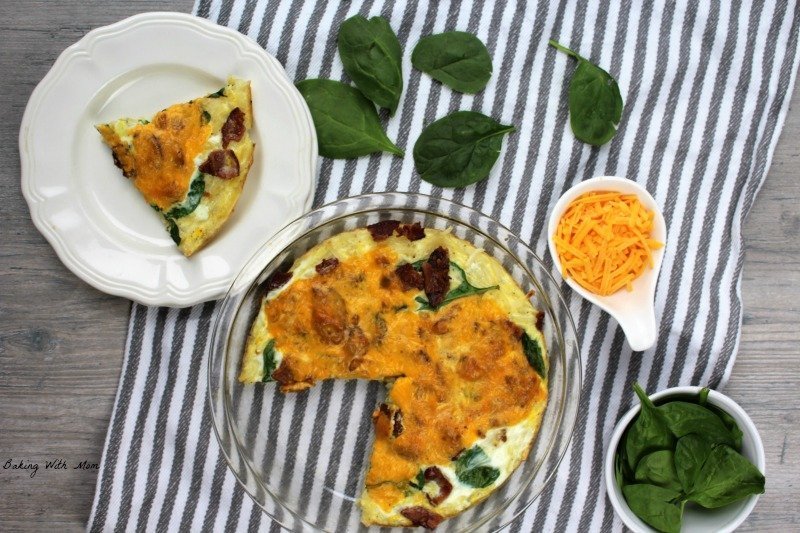 Bacon spinach quiche with a slice cut out