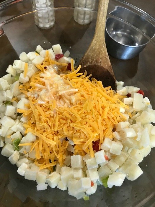 hashbrowns and cheese in a large glass bowl