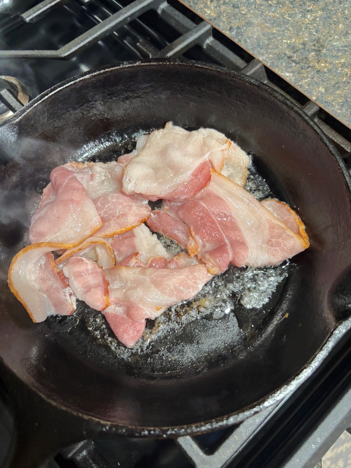 bacon frying in a pan.
