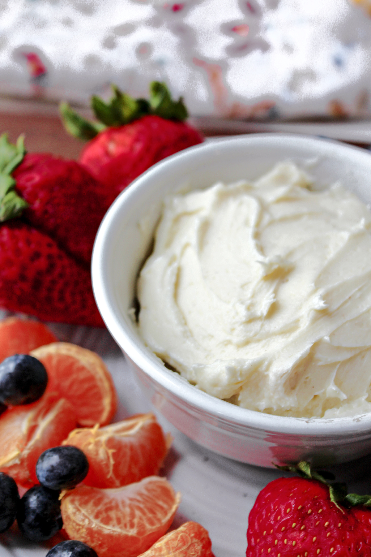 fruit dip on a plate with fruit besides. 