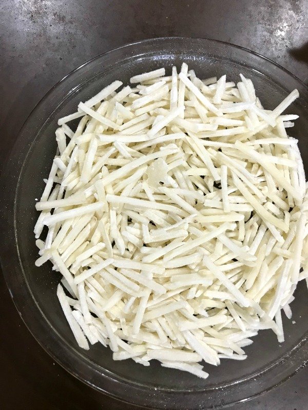 Shredded hashbrowns in a pie pan 