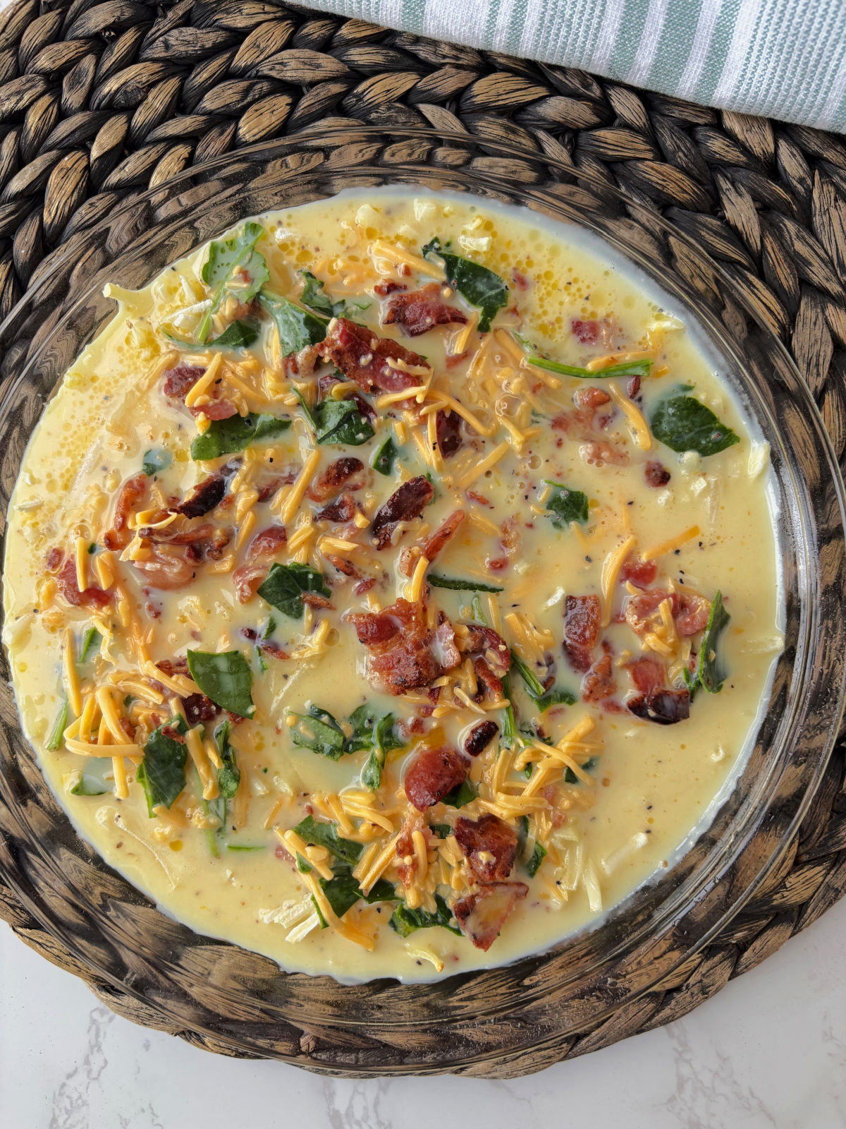 uncooked egg quiche in a pie pan.
