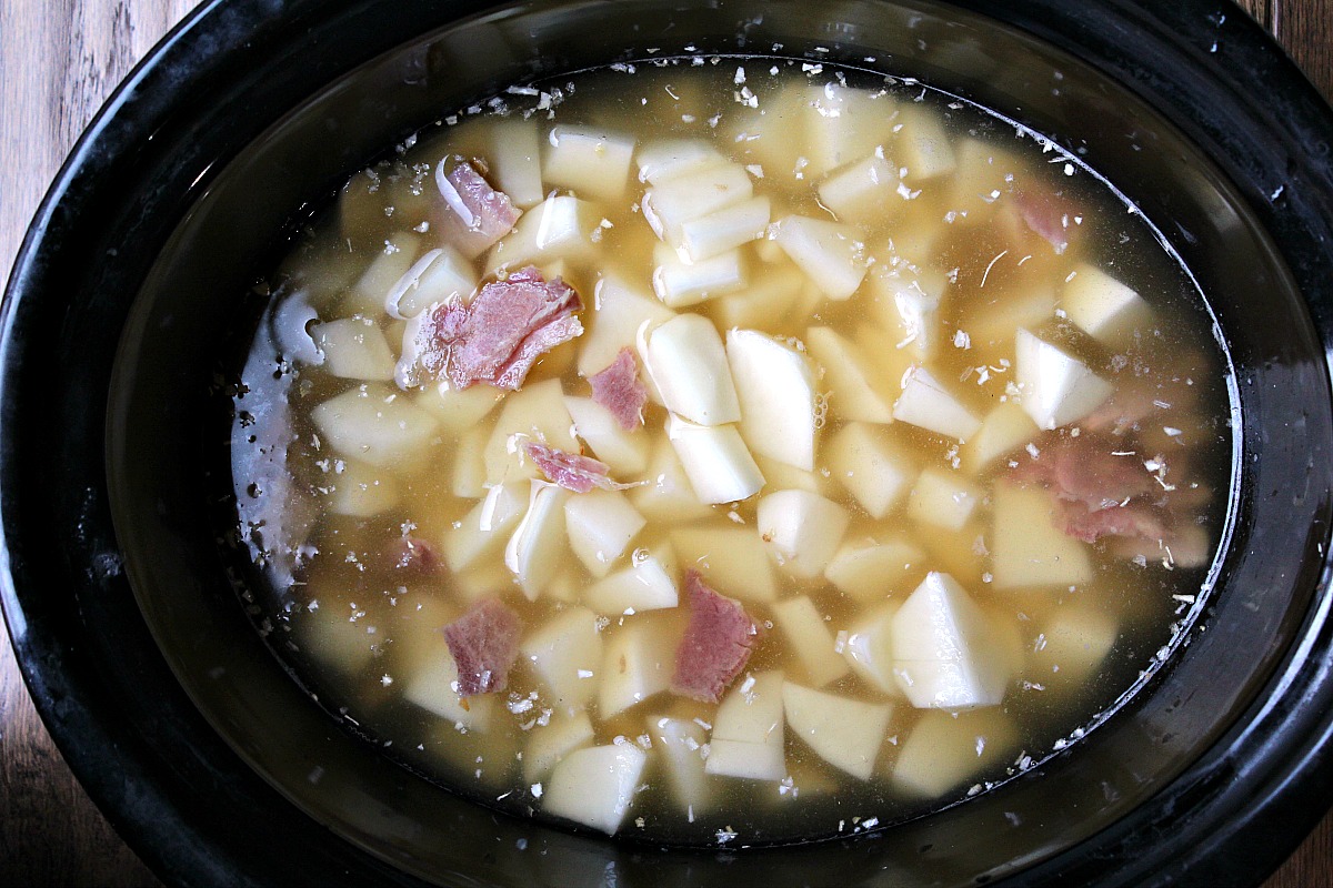 Potatoes, ham and chicken broth in a slow cooker