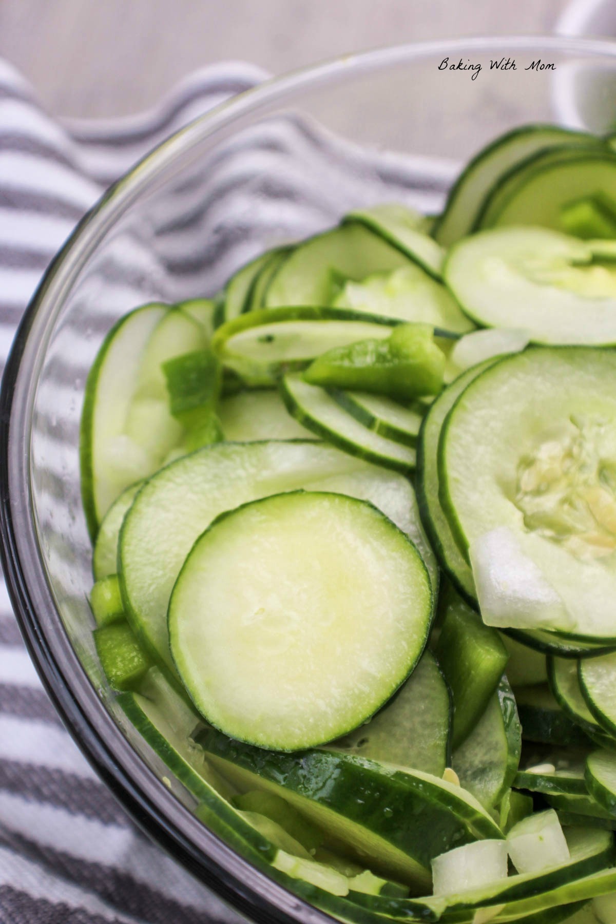 Cucumber Salad in a clear bowl with onions