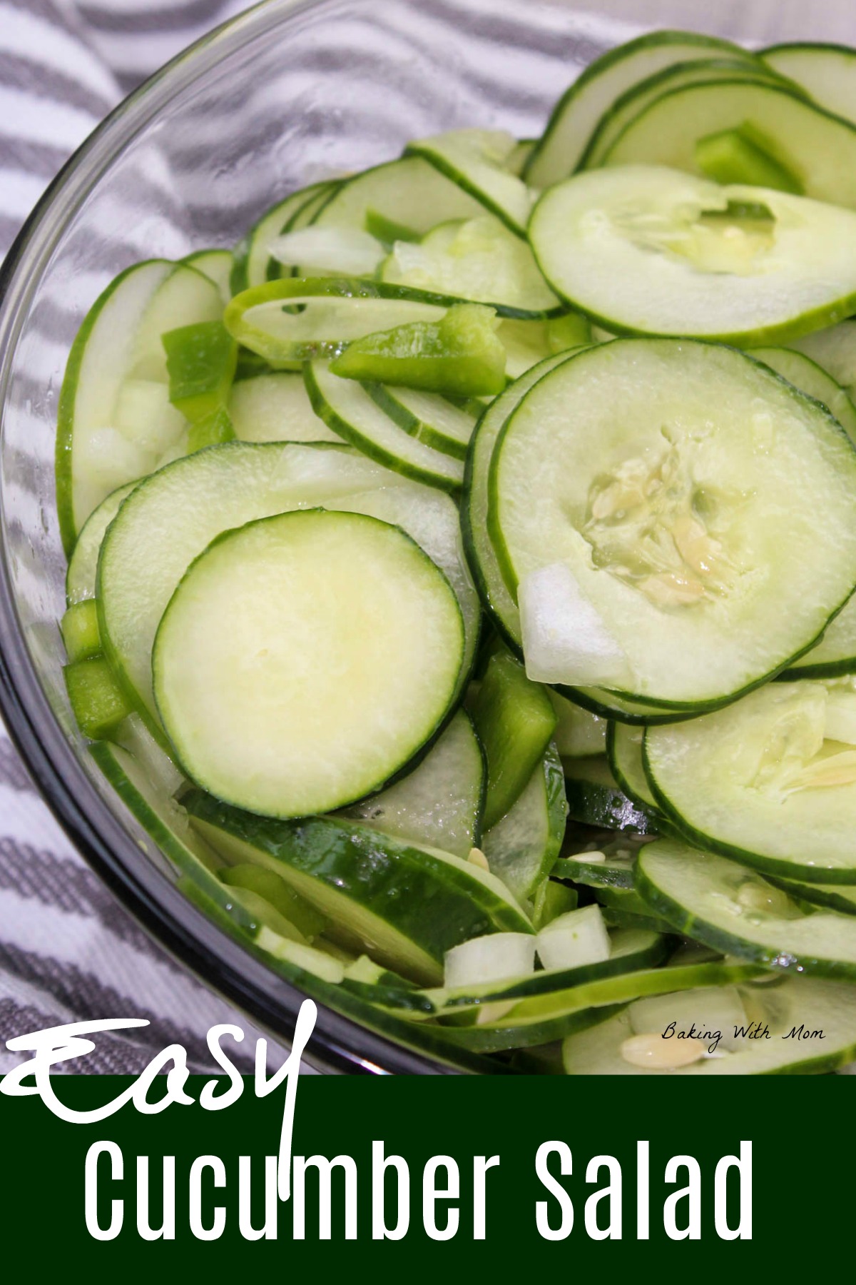Easy Cucumber Salad with peppers and onions in a bowl with a striped towel 
