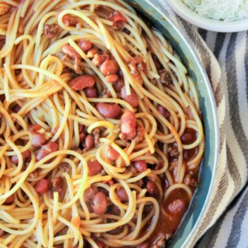 spaghetti noodles in a large pan with beans and sauce