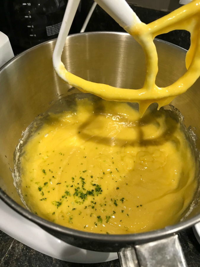 Cake batter in a mixing bowl with lime peel