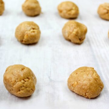 Peanut Butter Balls on waxed paper with a milk jug in the background