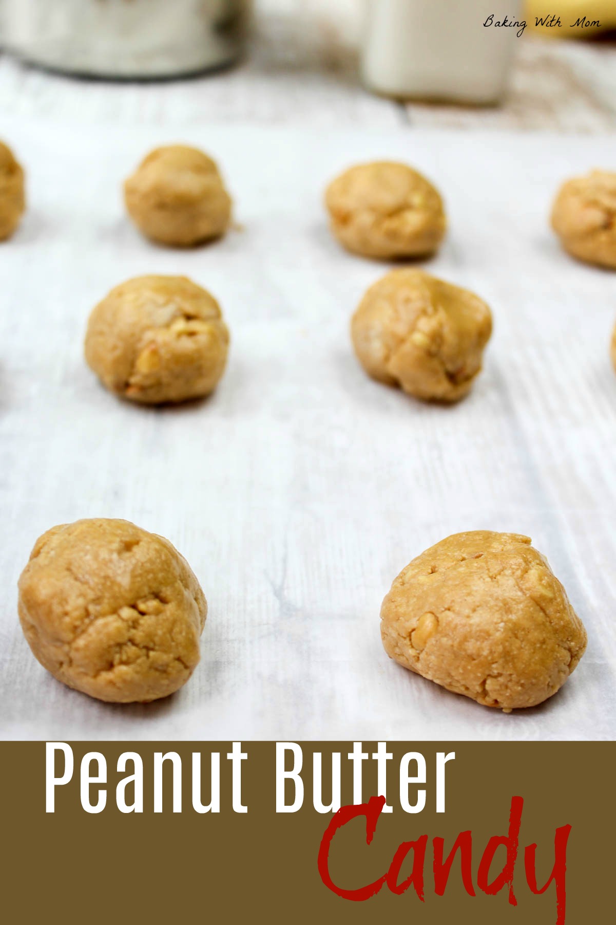 Peanut butter balls on a cookie sheet on waxed paper