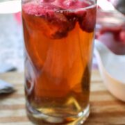 Glass of raspberry sorbet ice tea on a cutting board