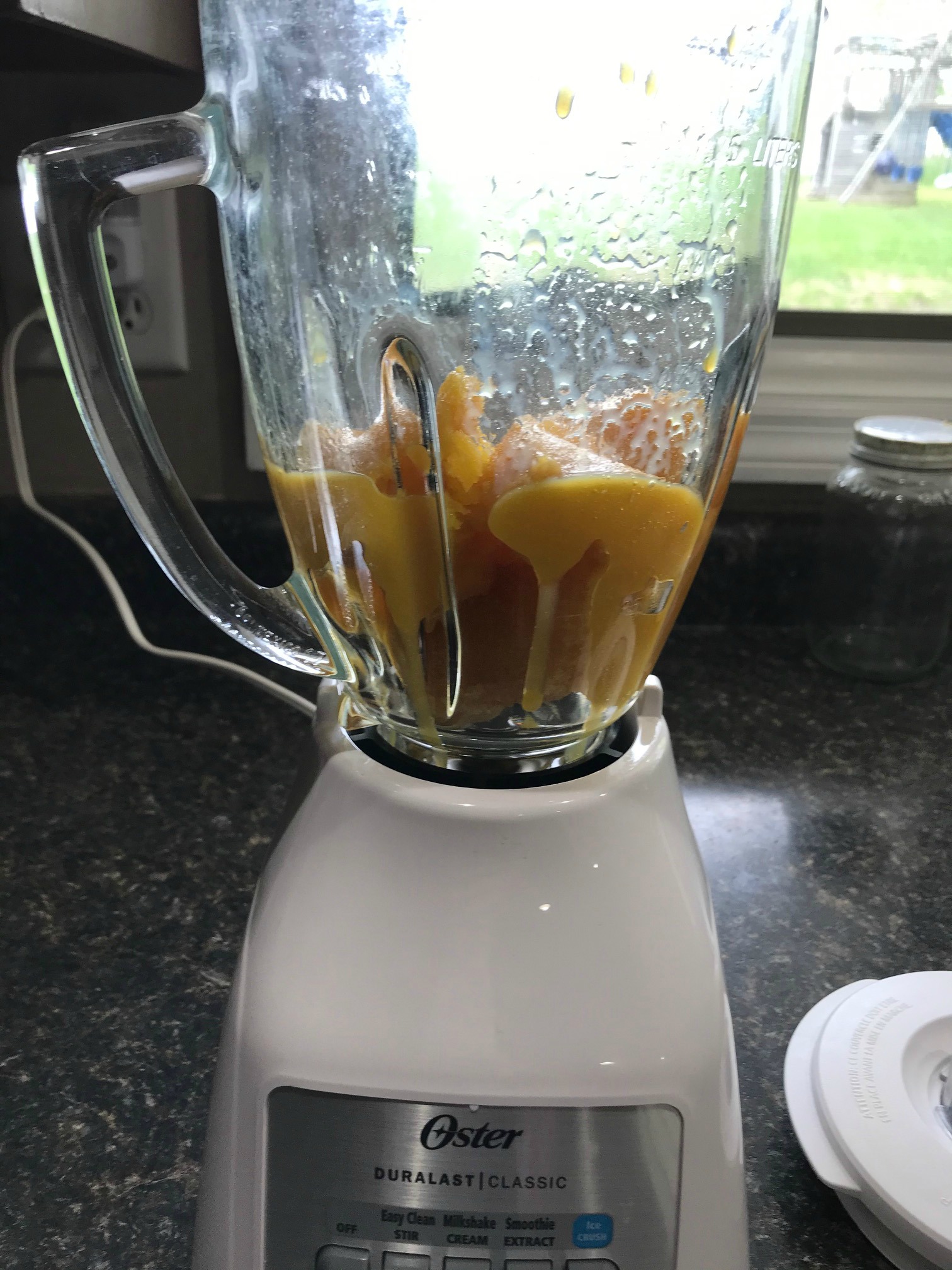 Frozen orange juice in a blender on a countertop