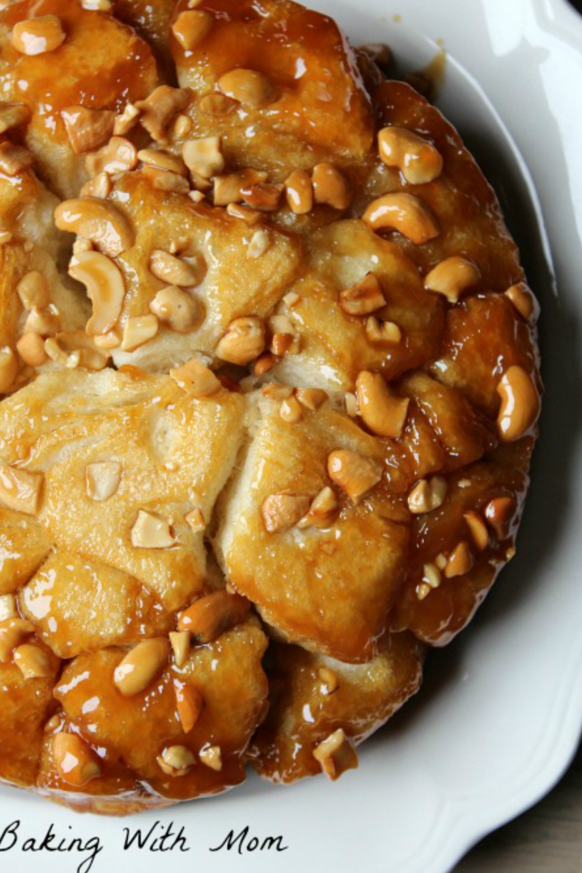 Caramel biscuits with cashews on top on a white plate