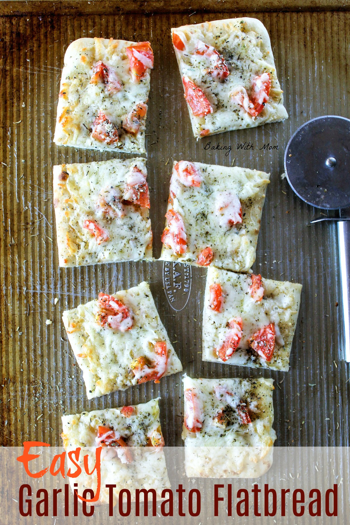 Slices of flatbread on a baking sheet with mozzarella cheese, Italian seasoning and tomatoes