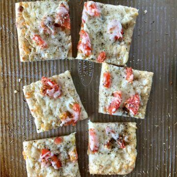 Cut easy garlic tomato flatbread on a cookie sheet