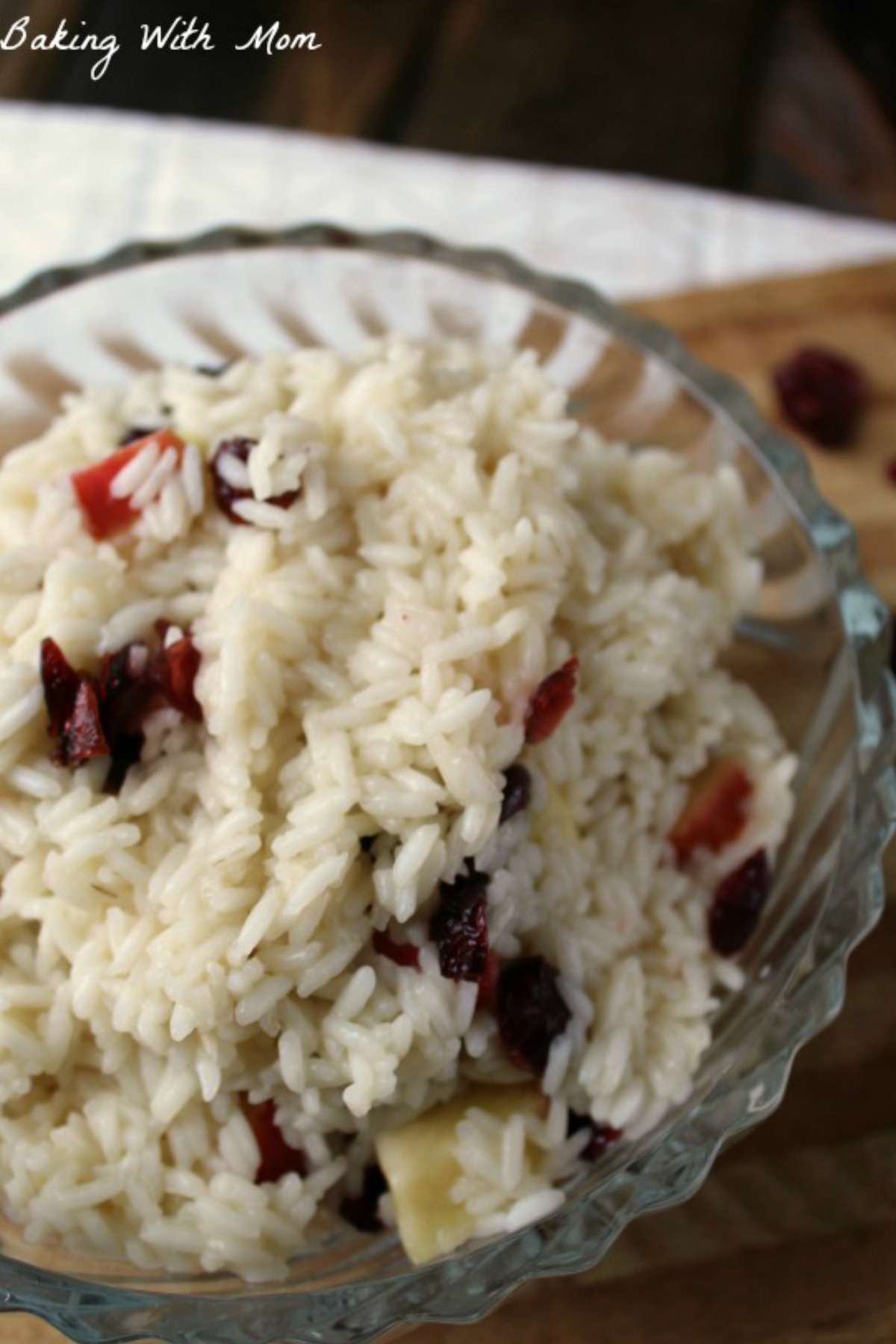 Rice with apples and dried cranberries in a clear bowl 