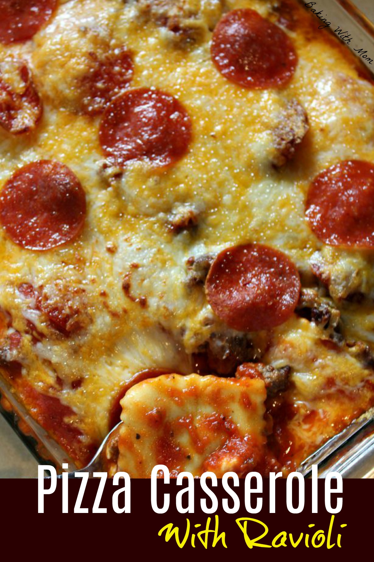 Pizza casserole with ravioli with pepperoni and cheese on top in a clear casserole dish