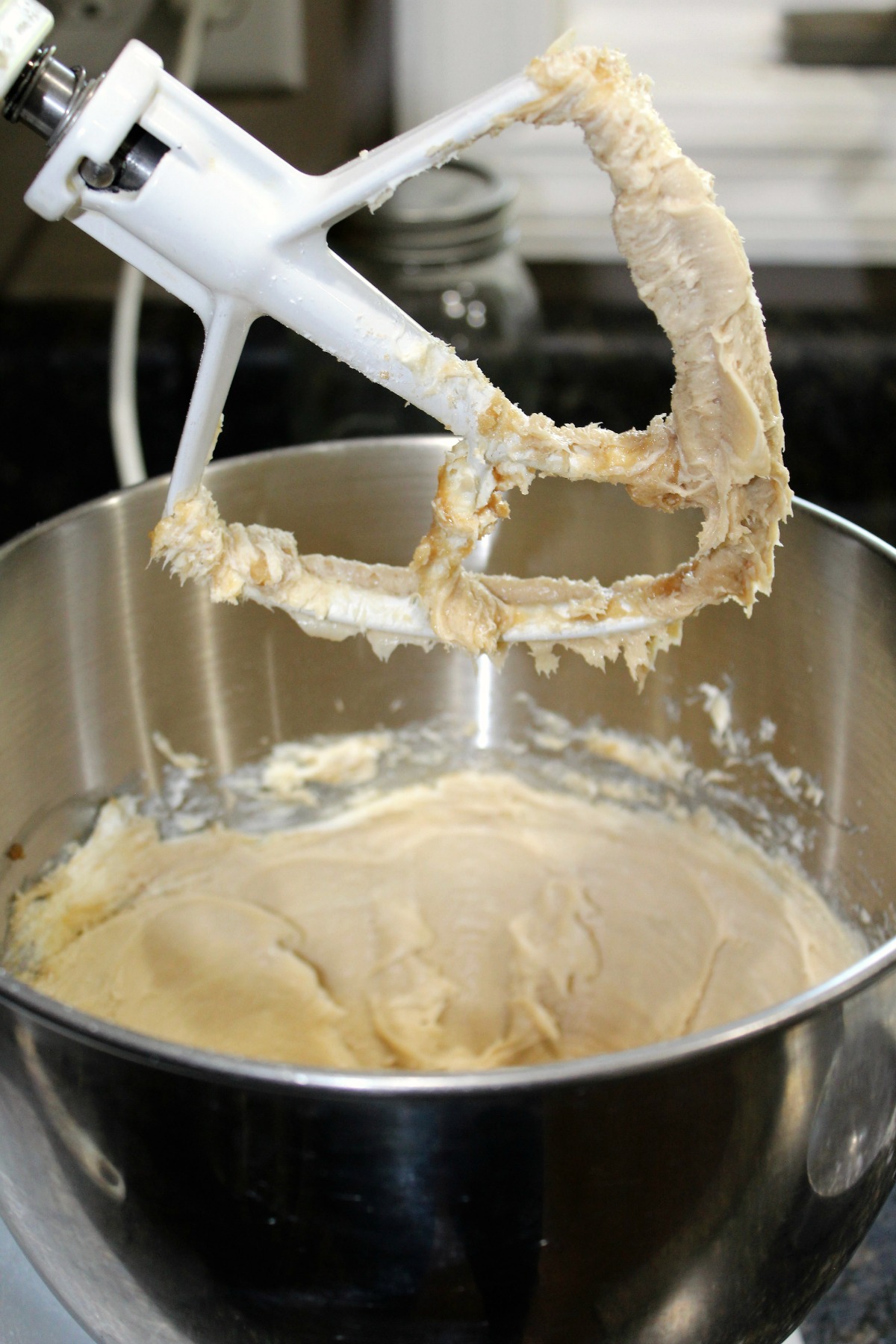 Stand mixer with cream cheese dip on the paddle 