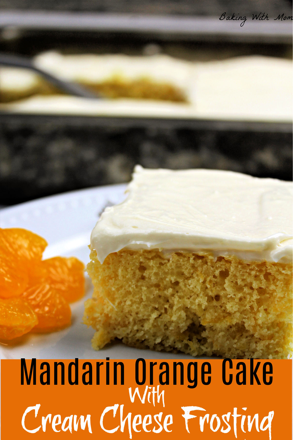 orange cake with cream cheese frosting on top on a white plate and cake pan behind.