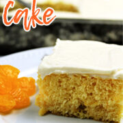 Mandarin Orange Cake slice with mandarins beside.