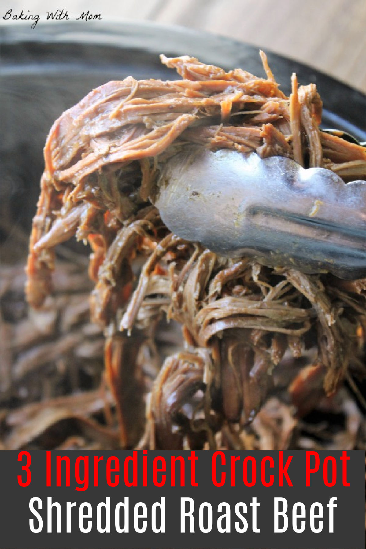 Shredded roast beef being held by tongs in a crock pot