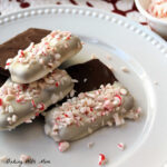 graham crackers covered in chocolate and peppermint stack in three