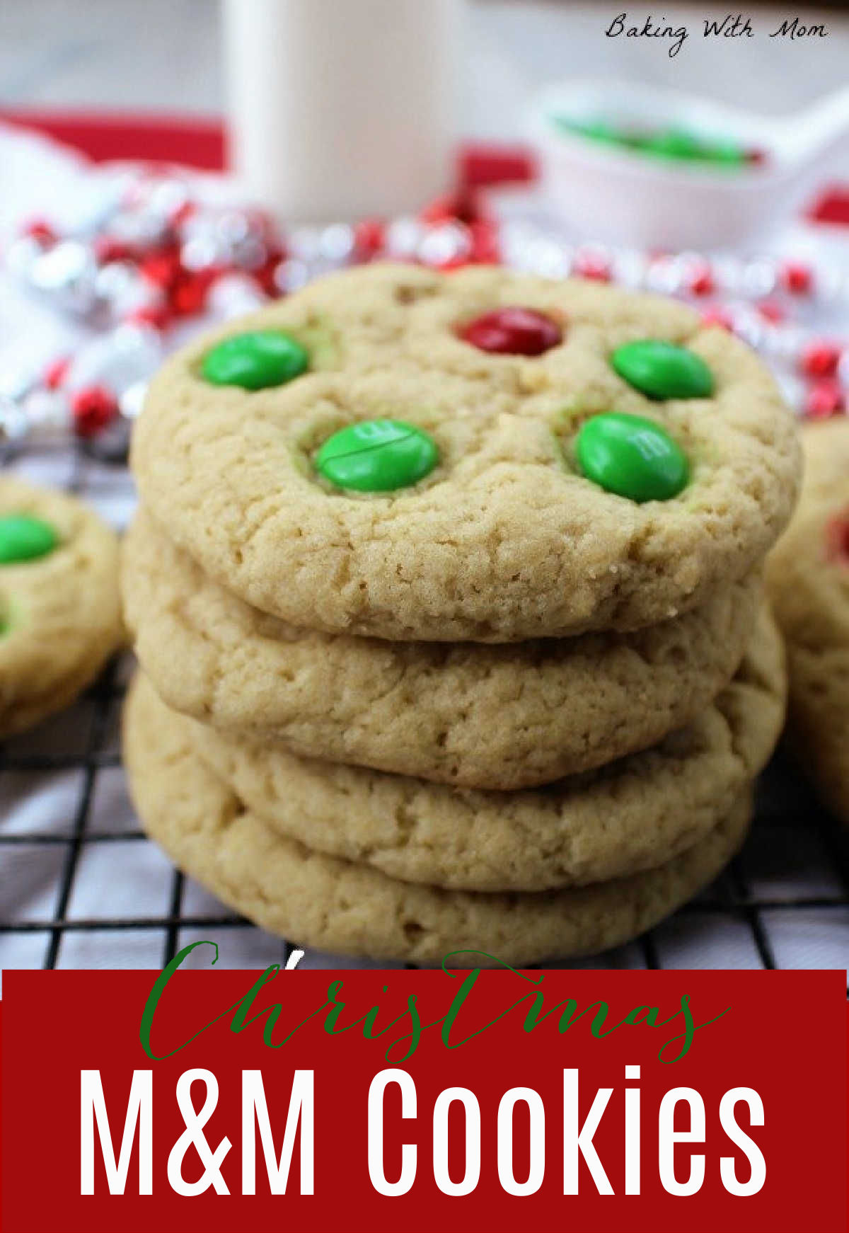 Stack of cookies on a cookie tray with red and green M&M's in them.