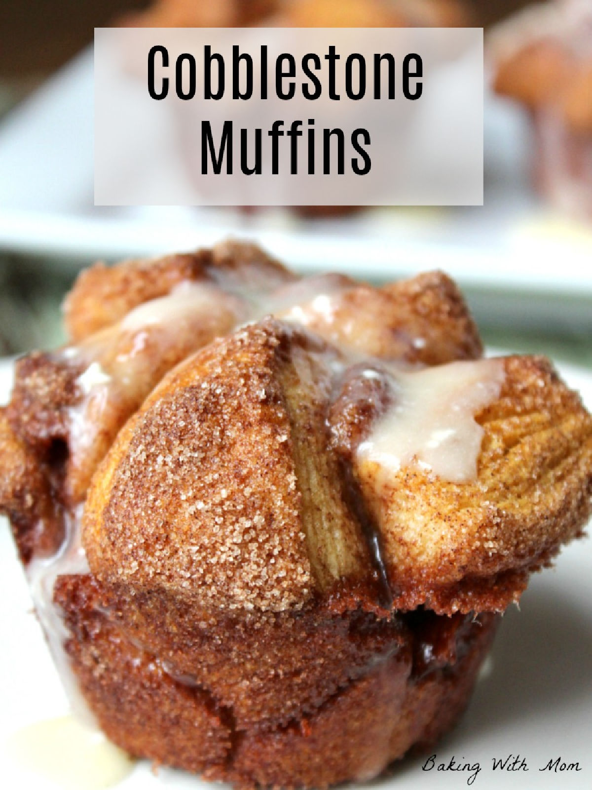 cinnamon sugar muffin sitting on a white plate drizzled with white frosting. 