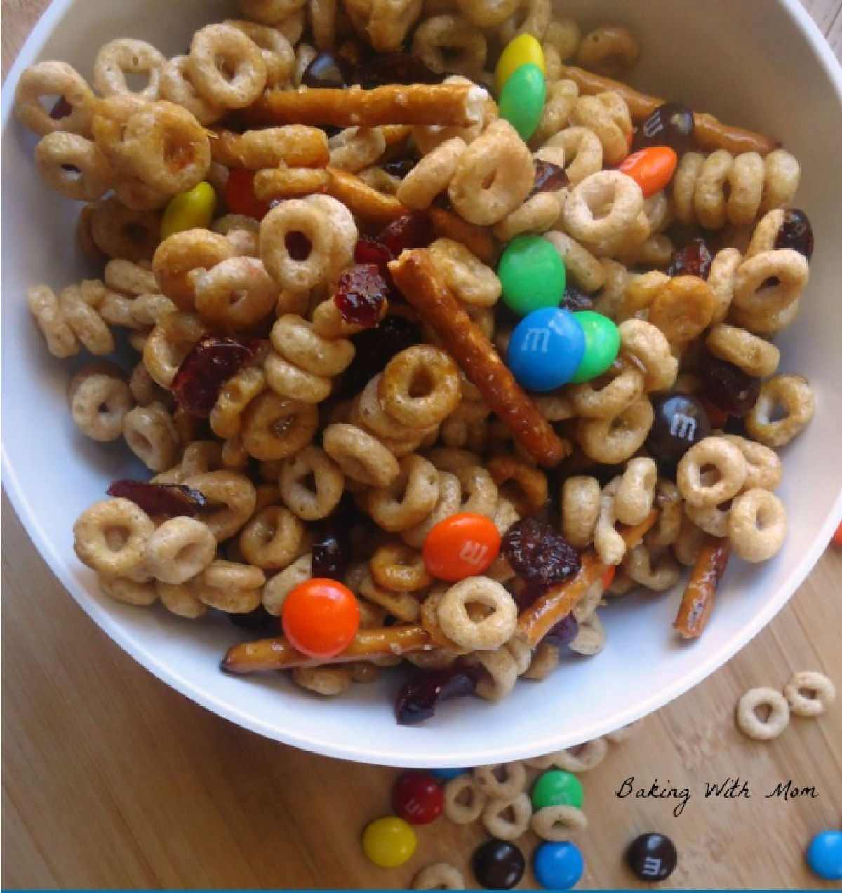 cheerios, m&m's, pretzels in a white bowl