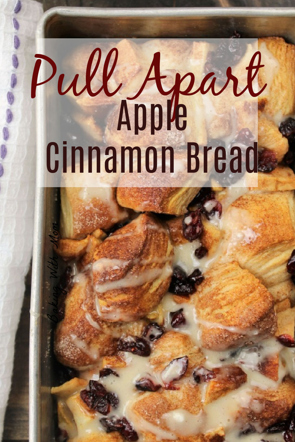 Apple cinnamon bread in a loaf pan with frosting drizzled on top.