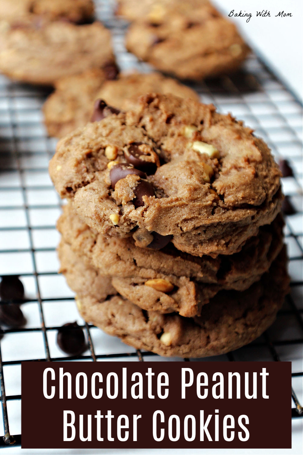 Stack of 3 cookies on a cooling rack with chocolate chips besides. 