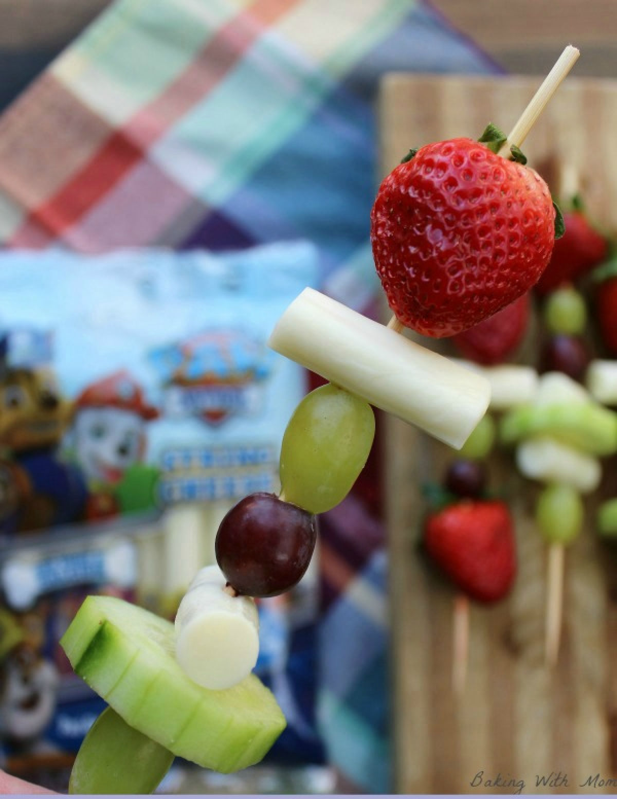 Easy snack kabobs with cucumbers, cheese, grapes and strawberries on a kabob stick. 