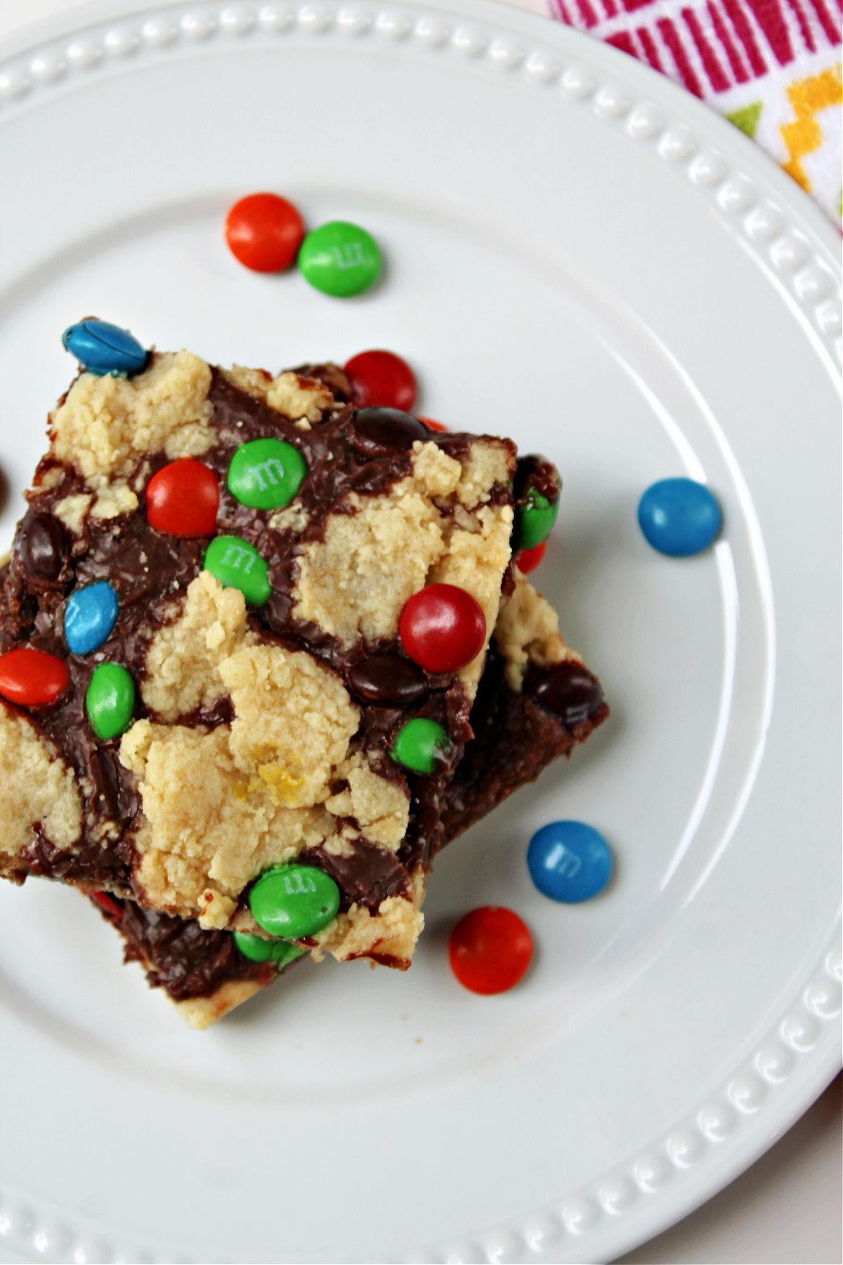 shortbread bars on a white plate with mm's on the plate.