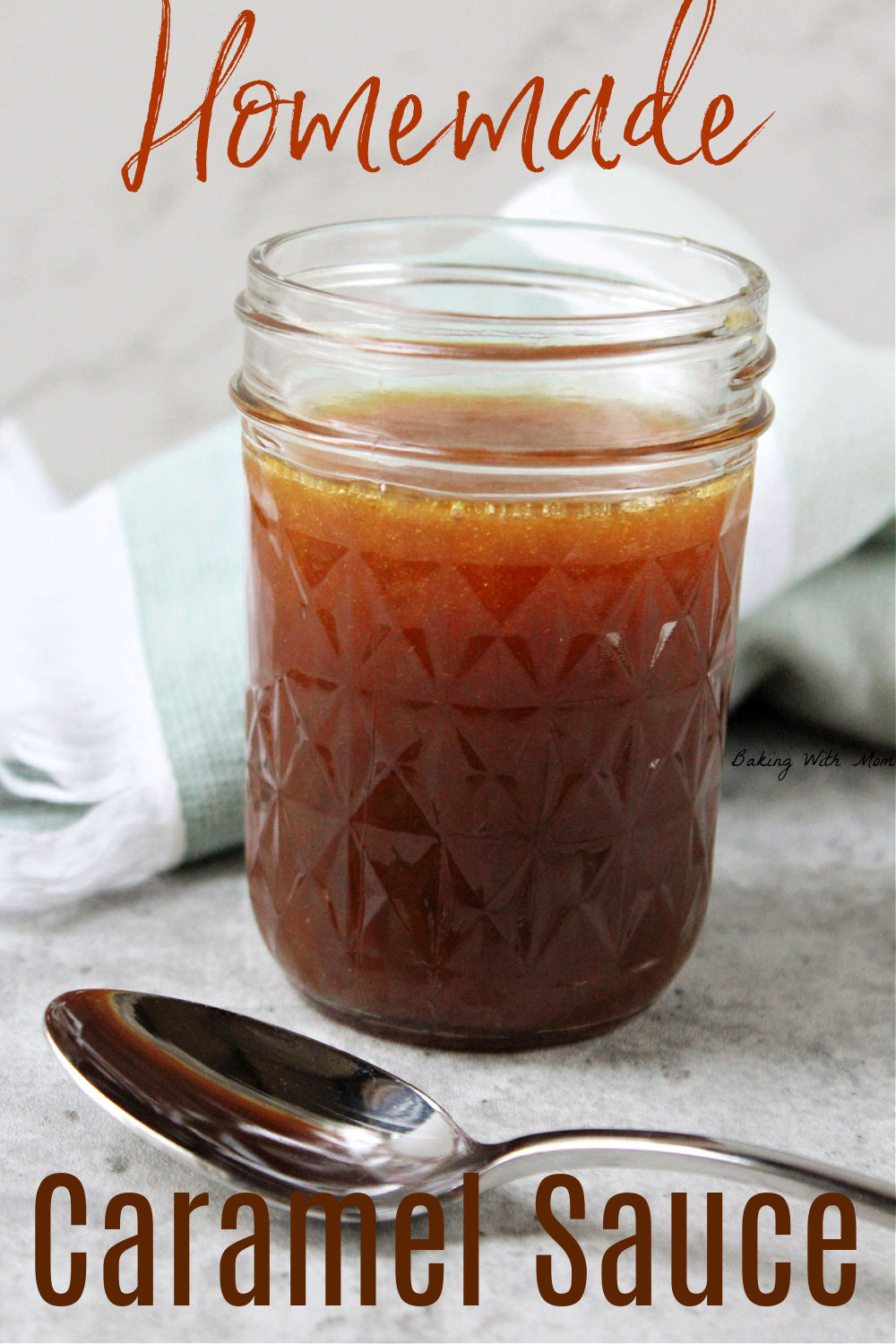 Jar of caramel sauce with a spoon laying besides.