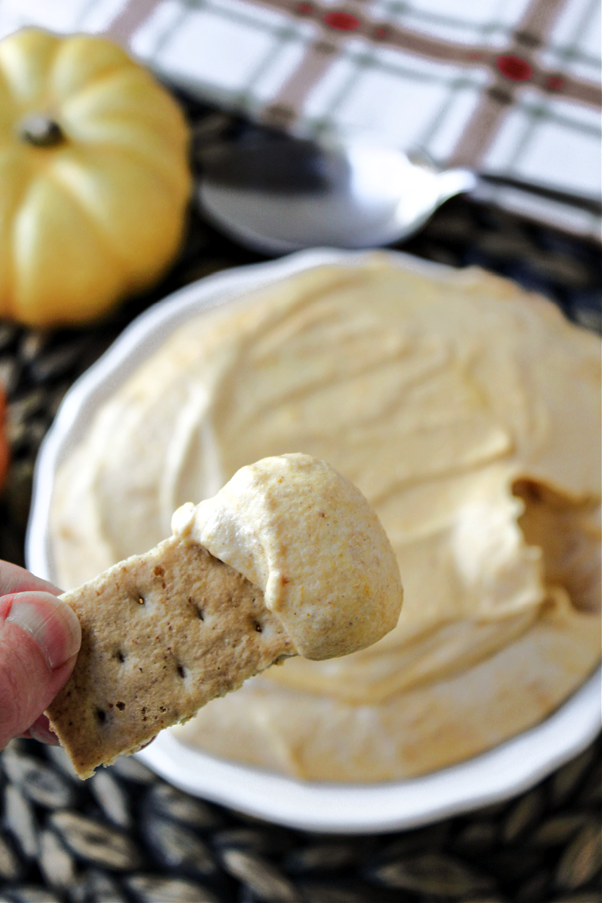 graham cracker with pumpkin dip on it.