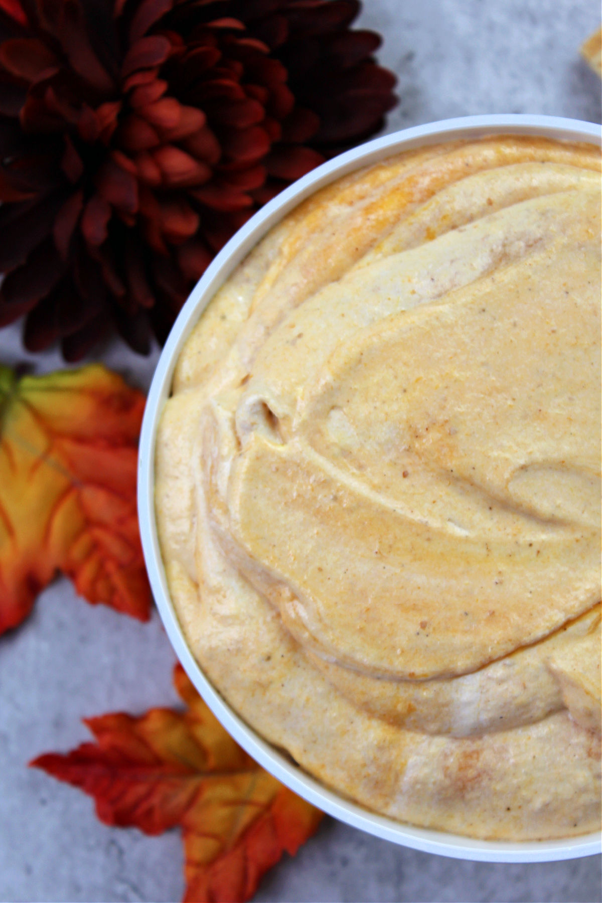 close up of pumpkin pie dip in a white bowl.