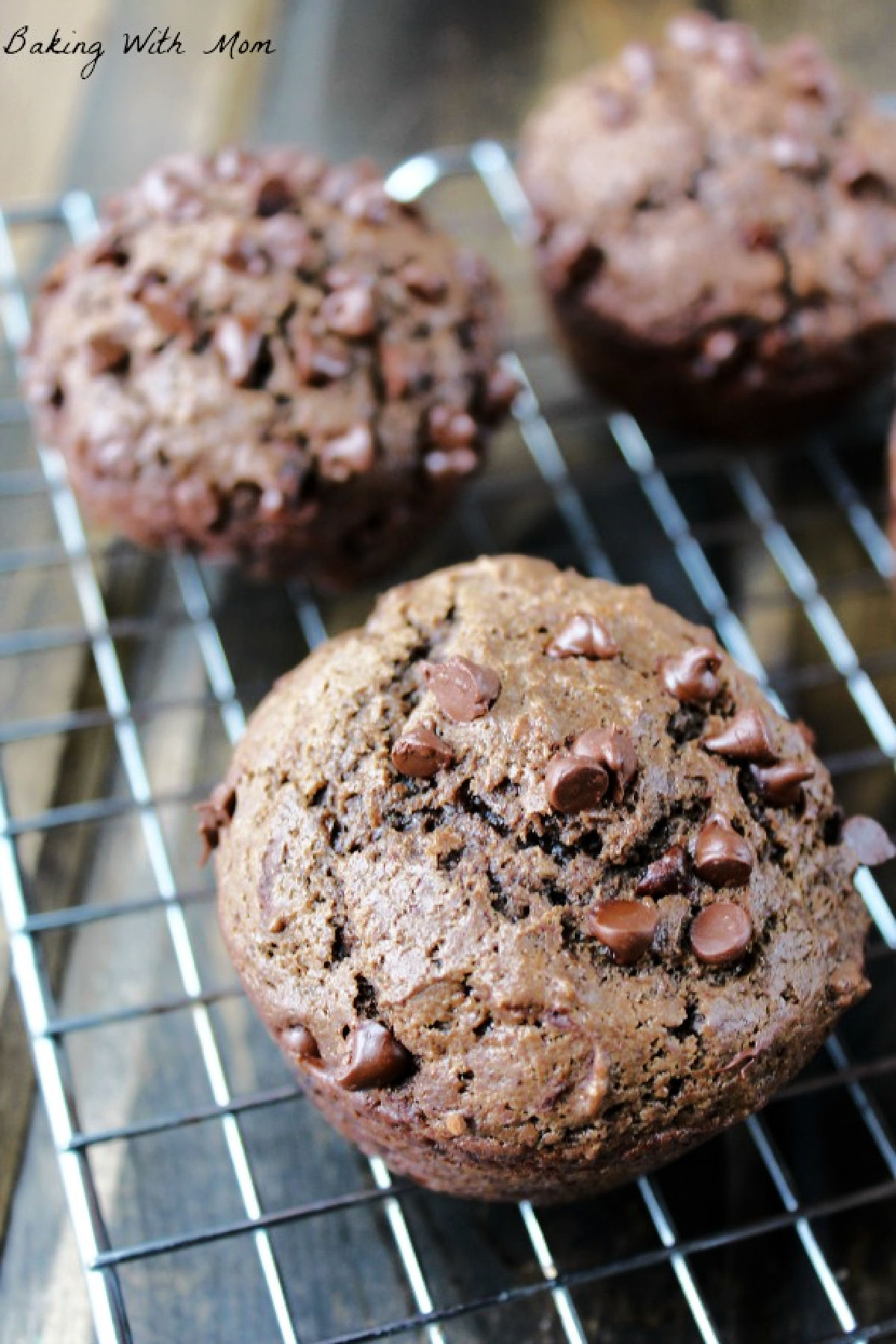 chocolate muffin sitting on a cooling rack