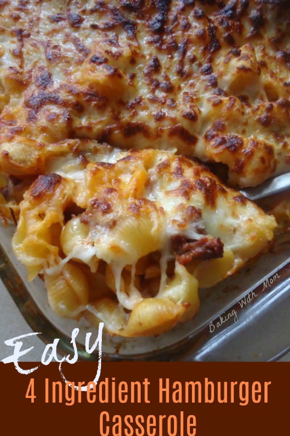 hamburger casserole of noodles, tomato soup and cheese in a clear baking dish.