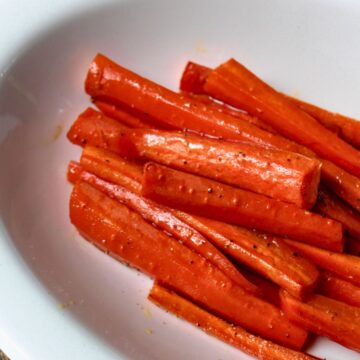 glazed carrots in a white bowl.