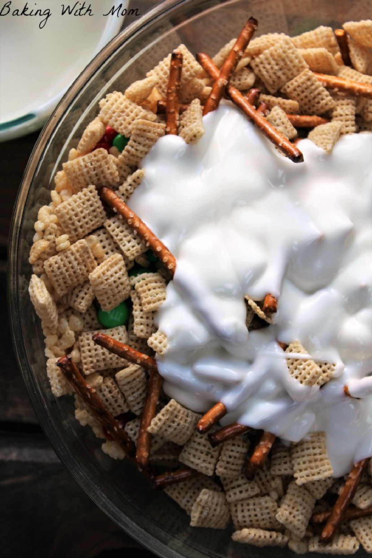 Vanilla almond bark poured on top of the cereal snack mix. 