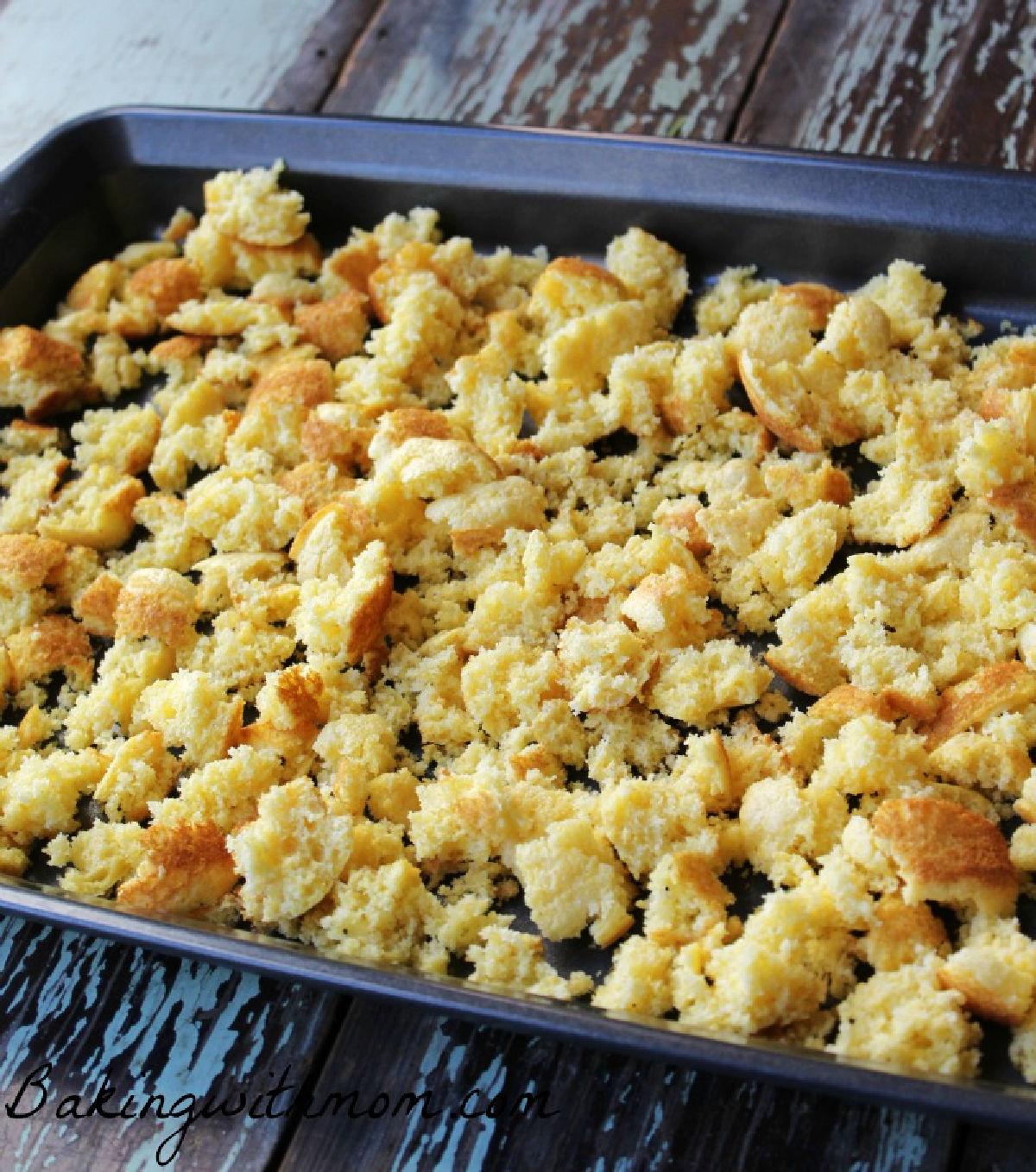 Cornbread in a baking pan ready to be toasted. 