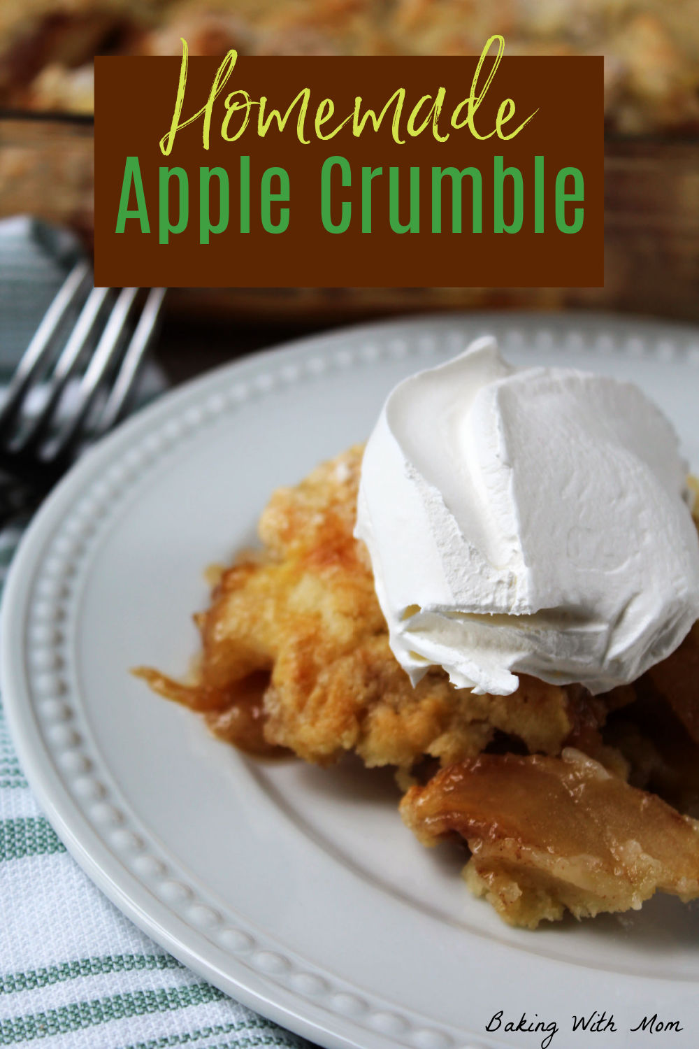 Apple crumble on a white plate with a scoop of whipped cream on top. 